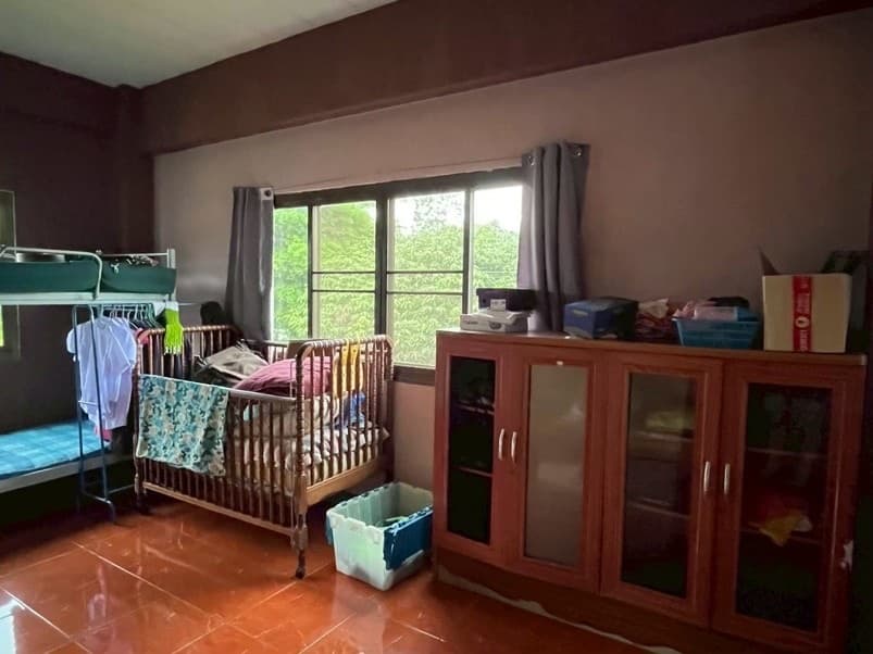 A bedroom at the home, a bunk and a crib